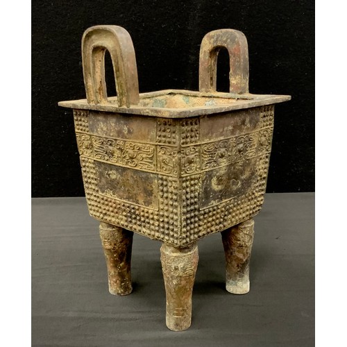 297 - A bronzed metal Chinese twin handled archaic style koro, 24cm high