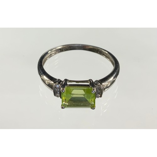 359 - A peridot and diamond ring, central emerald cut peridot between round brilliant cut diamonds, 9ct wh... 