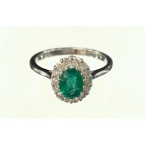 364 - An emerald and diamond cluster ring, central emerald approx 0.86ct surrounded by fourteen round bril... 