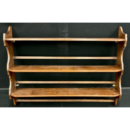 254A - A walnut stained hardwood three tier plate rack, wall mounted, 82.5cm high x 107cm wide x 16cm deep.