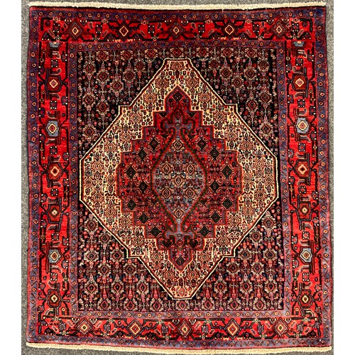 65A - A North West Persian Senneh rug / carpet, hand-knotted with concentric diamond-shaped medallions wit... 