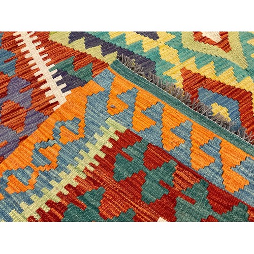 200A - A Turkish Anatolian Kilim rug, knotted with a traditional design, in bright colours, red, orange, tu... 