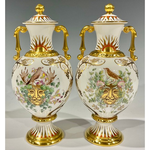 32 - A pair of Royal Crown Derby two handled pedestal baluster vases and covers, printed and painted with... 