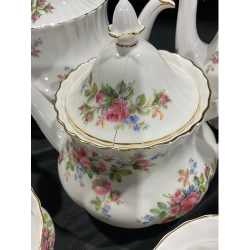 35 - A Royal Albert Moss Rose pattern tea service, comprising a large teapot and cover, a medium teapot a... 