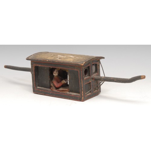 3228 - An Indian painted softwood model, of a palanquin,  with European occupant, 33cm overall, 19th centur... 