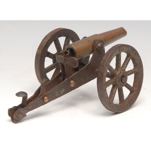 3219 - An early 20th century trench art model cannon, the barrel formed from a brass bullet casing, 13.5cm ... 