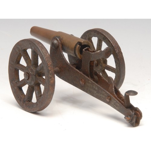 3219 - An early 20th century trench art model cannon, the barrel formed from a brass bullet casing, 13.5cm ... 