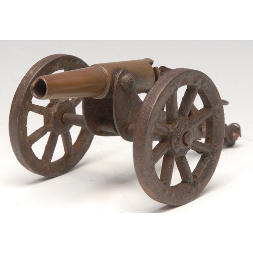 3219 - An early 20th century trench art model cannon, the barrel formed from a brass bullet casing, 13.5cm ... 