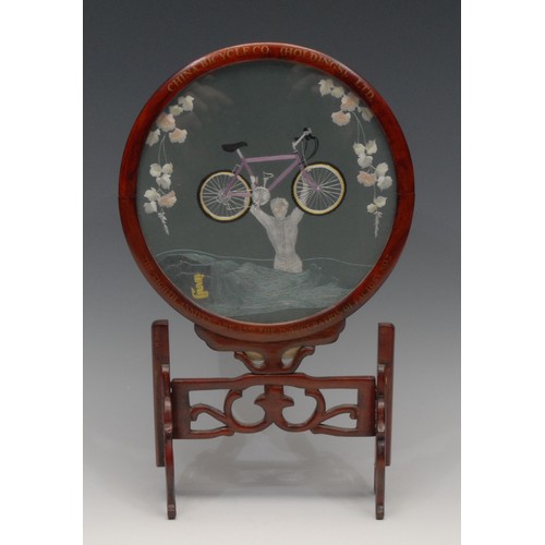 3070 - A Chinese hardwood table screen, the circular banner worked in coloured silks with a boy carrying hi... 