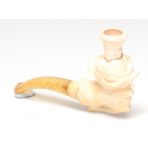 3106 - A German meerschaum novelty cheroot holder, carved as a hand holding a rose, 8cm long, early 20th ce... 