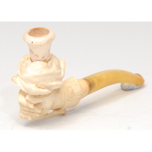 3106 - A German meerschaum novelty cheroot holder, carved as a hand holding a rose, 8cm long, early 20th ce... 