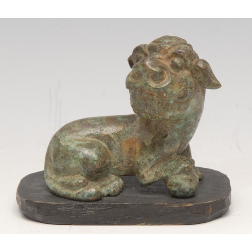 3080 - A Chinese verdigris patinated bronze, of a temple lion, in the Archaic taste, 6cm long