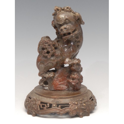 3076 - A Chinese soapstone carving, of a temple lion, bronze base, 18.5cm high