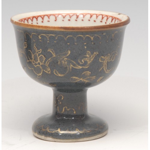 3079 - A Chinese stem cup, decorated in gilt on a powder blue ground, the interior with a flower sprig and ... 