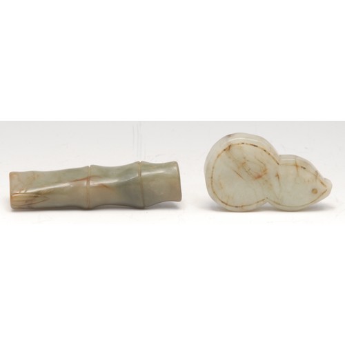 3072 - A Chinese jade toggle, carved as a section of bamboo, 8.5cm long; another (2)