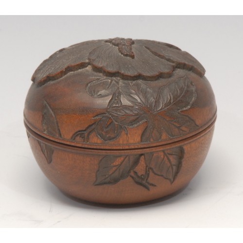 3116 - A Japanese boxwood box and cover, carved with a lotus, signed paper label, 7cm diam,