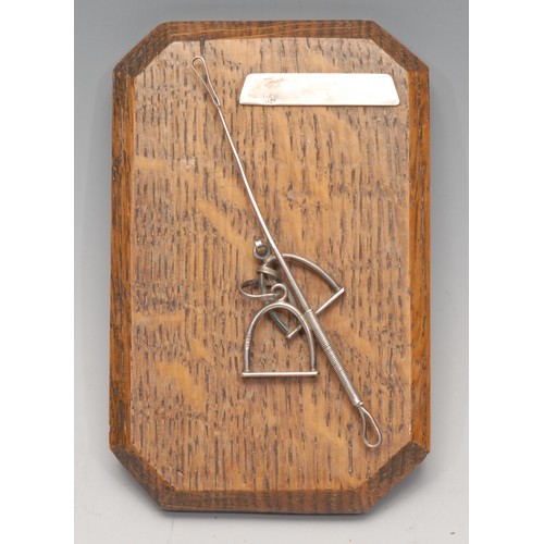 3217 - An early 20th century silver and oak canted rectangular novelty letter clip, of equestrian interest ... 