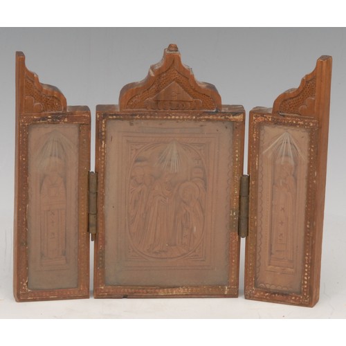 3165 - A Russian boxwood travelling triptych icon, carved with saints, 12cm wide (open), titled in Cyrillic... 