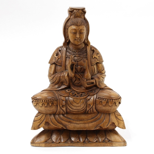 3068 - A Chinese hardwood carving, of Bodhisattva Guanyin, seated in a lotus and holding a bottle, 31cm hig... 