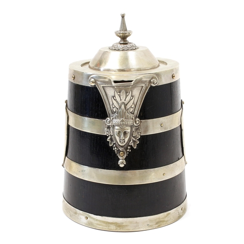 3134 - A late Victorian E.P.N.S mounted oak flagon, hinged cover with spire-knop finial, the spout and wryt... 