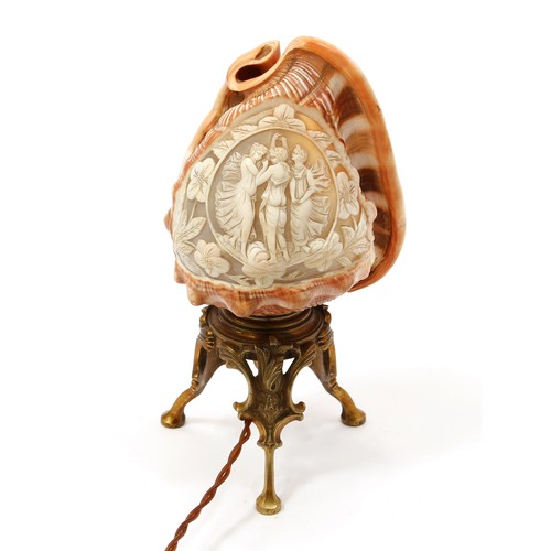 3203 - An early 20th century cameo conch shell table lamp, carved with The Three Graces, cast base, 23cm hi... 