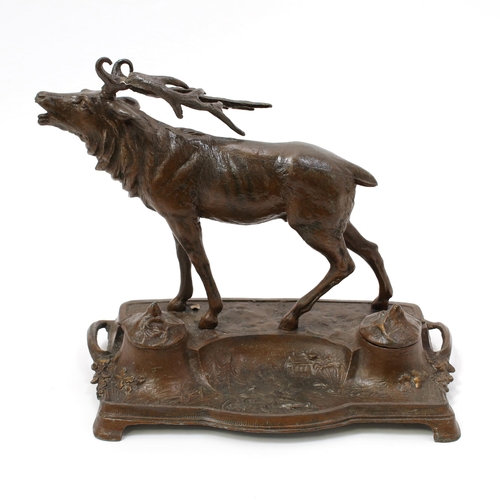 3218 - An early 20th century spelter novelty inkstand, cast with a stag, hinged covers, 27cm wide