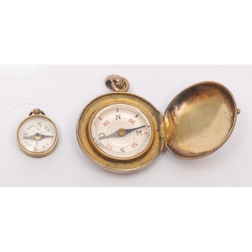 3246 - A 19th century gilt metal compass watch fob, of locket form, 2.5cm diam; another, miniature (2)