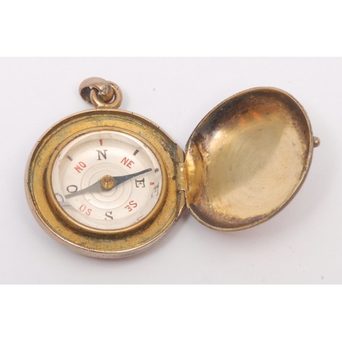 3246 - A 19th century gilt metal compass watch fob, of locket form, 2.5cm diam; another, miniature (2)