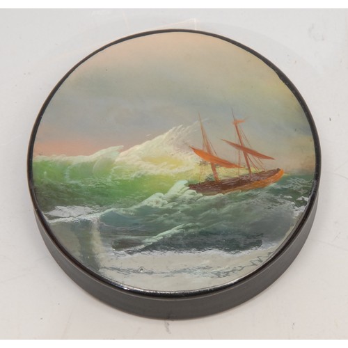 3166 - A Russian lacquer circular snuff box, the push-fitting cover painted with a ship on a stormy sea, 6c... 