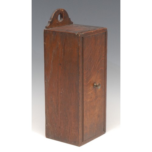 3102 - A George III oak candle box, arched cresting, sliding cover, 31cm high, c.1800