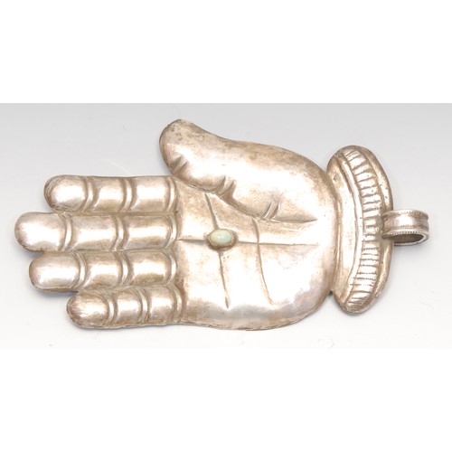 3172 - A South American silver coloured metal milagro votive, as a hand, the palm collett set with a turquo... 