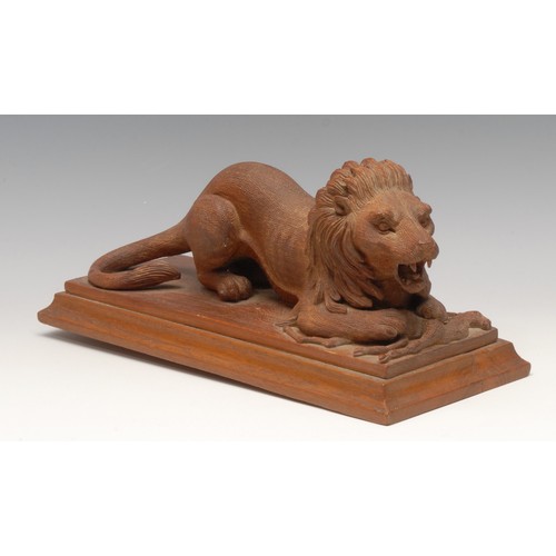 3204 - An early 20th century carving, of a lion and his kill, rectangular base, 29cm long