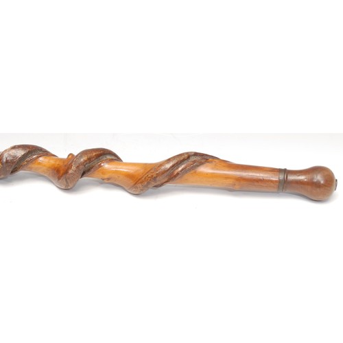 3400 - A 19th century twisted hazel walking stick, hardwood knop set with a silver coloured metal armorial ... 