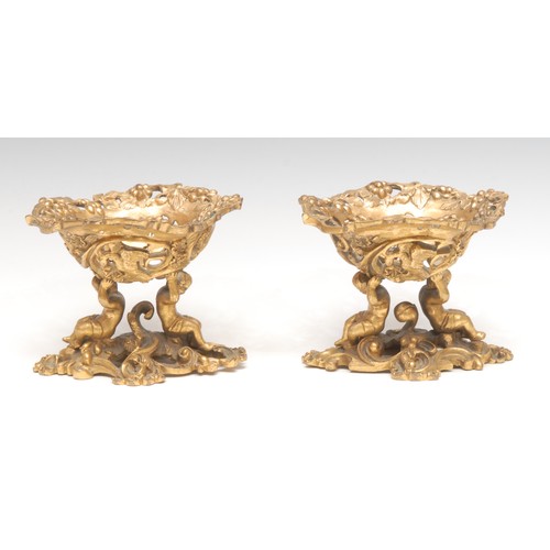 3151 - A pair of 19th century ormolu sculptural sweetmeat stands, cast in the Baroque taste with scantily c... 