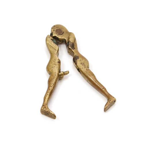 3595 - Nutcrackers - Erotica - a 19th century brass lever-action nut cracker, erotic subject, 8.5cm long