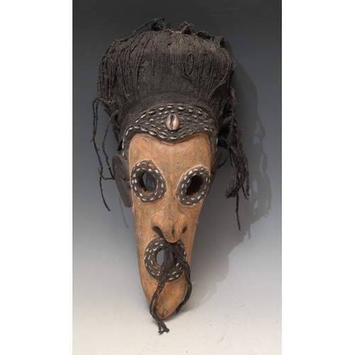 3433 - Tribal Art and the Eclectic Interior - a mask, the bold features outlined with cowrie shells, textil... 