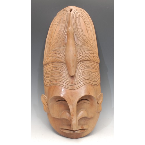 3440 - Tribal Art and the Eclectic Interior - a Papua New Guinea mask, stylised concave features, protrudin... 