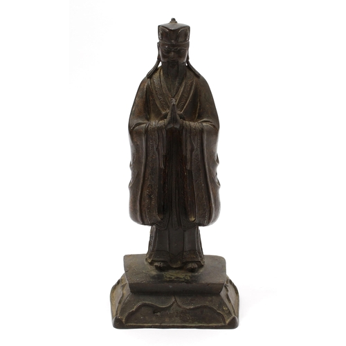 3245 - Chinese School (17th/18th century), a dark patinated bronze, of a Daoist Immortal, traces of gilding... 