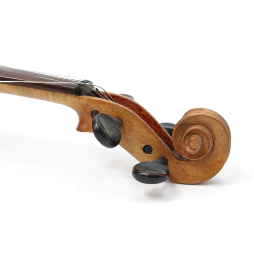 3370 - A violin, the two-piece back 36.5cm excluding button, ebonised tuning pegs, outlined throughout with... 