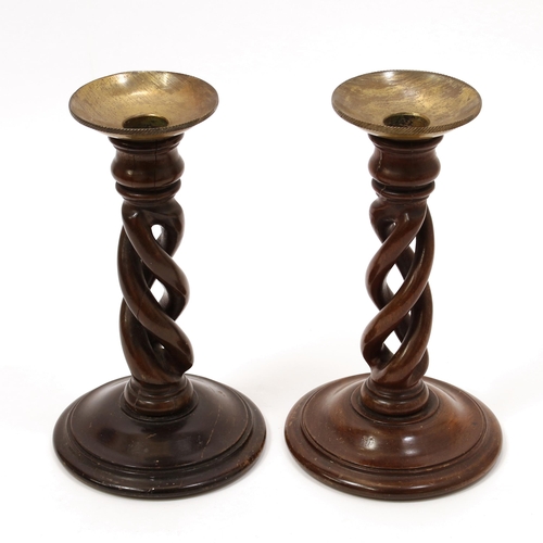 3351 - Treen - a pair of 19th century mahogany open-twist table candlesticks, brass sconces, domed circular... 