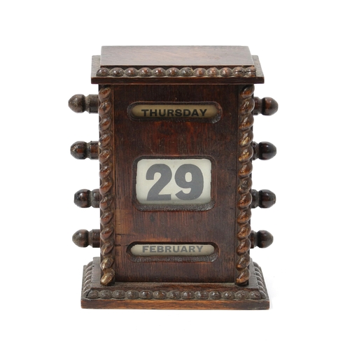 3213 - An early 20th century oak perpetual desk calendar, glazed apertures for day, date and month, 16cm hi... 