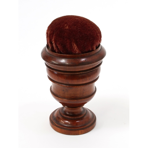 3348 - Treen - a 19th century turned mahogany campana shaped sewing companion, the push-fitting cover with ... 