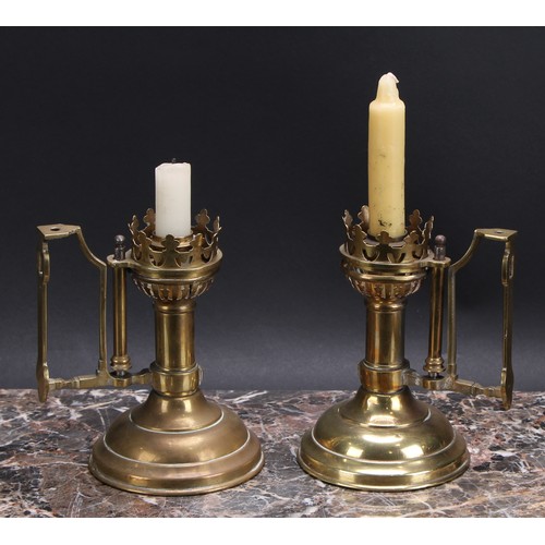 3158 - A pair of Gothic Revival brass chamber sticks, domed circular bases, 16.5cm to tops of handles, late... 