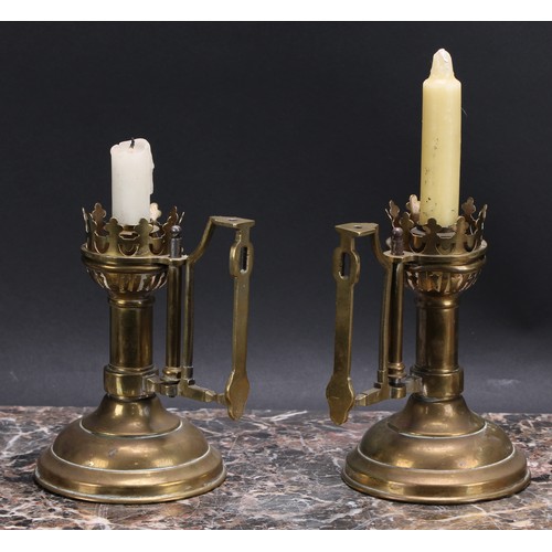 3158 - A pair of Gothic Revival brass chamber sticks, domed circular bases, 16.5cm to tops of handles, late... 