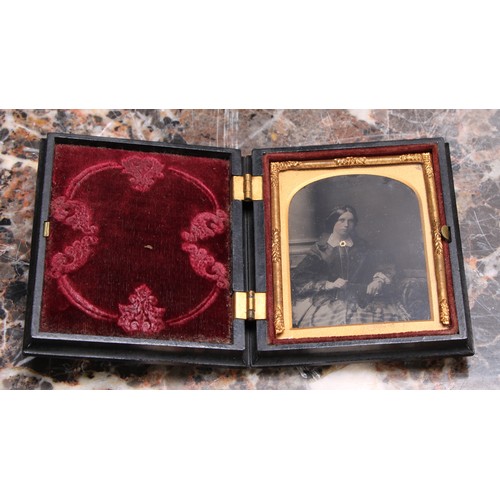 3612 - Photography - a 19th century ambrotype photograph, of a young lady holding a book, the union case mo... 