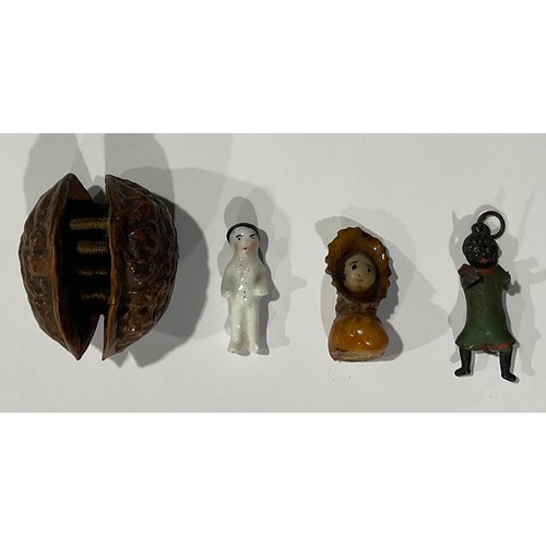 121 - A Victorian miniature doll in walnut shell; a miniature cast and cold painted Robinson’s style doll;... 