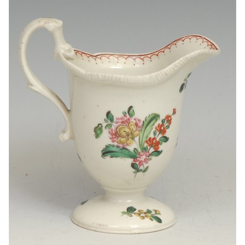 126 - A Liverpool helmet shaped pedestal cream jug, painted in polychrome with flowers, red double-line pe... 