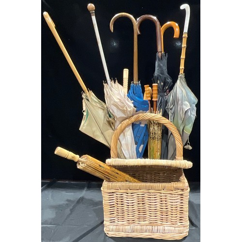 219 - A collection of mid 20th century and later umbrellas and parasols; a wicker picnic and wine basket (... 