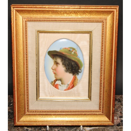 236 - A 19th century German porcelain oval plaque, probably Berlin, portrait of a young boy wearing a hat,... 