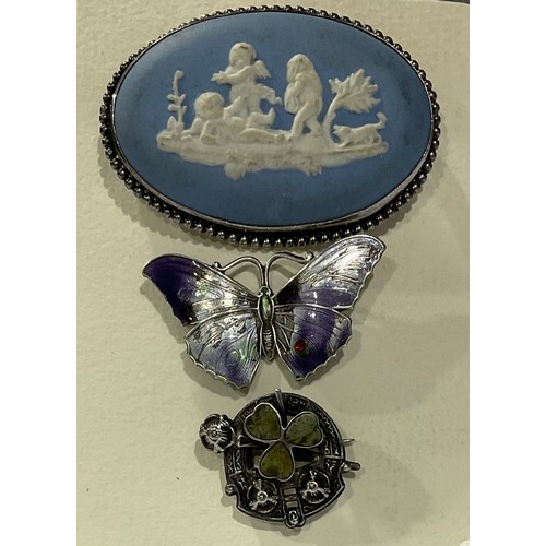 252 - A hallmarked silver and enamel butterfly brooch; a Wedgwood brooch; a Shamrock silver brooch